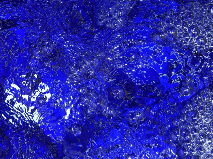 a background with bright blue tinsel in a blue hue