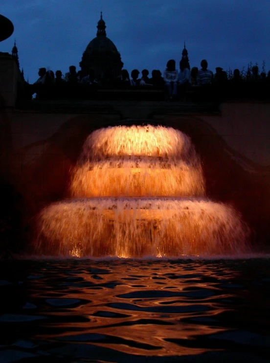 a large water fountain has the dome behind it