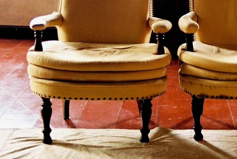 two yellow chairs side by side on a carpeted floor