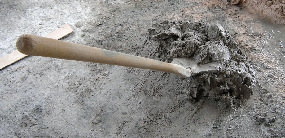 there is sand on the ground next to a baseball bat