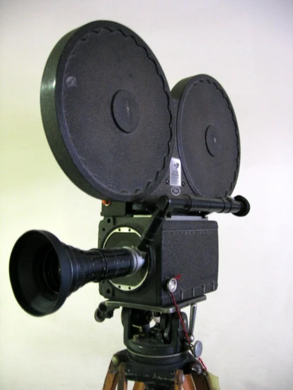 an old style movie projector with a camera mounted on a tripod