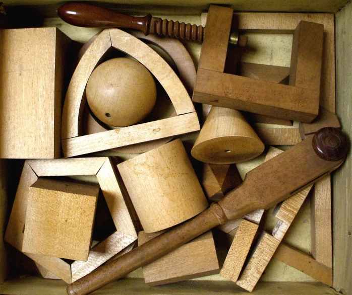 wooden toys are in a box with wooden spoons