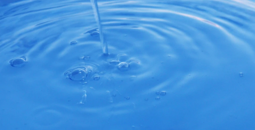 blue water has some bubbles that appear to be coming out