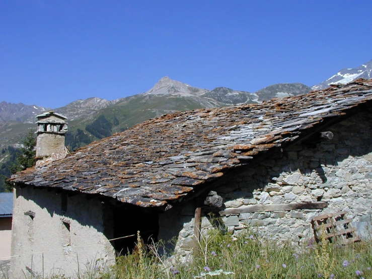 there is a very old building with some rocks in front