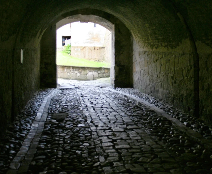 a brick road that runs in to a tunnel