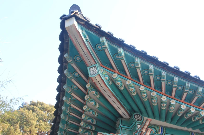 the side of a blue and red building with decorative designs