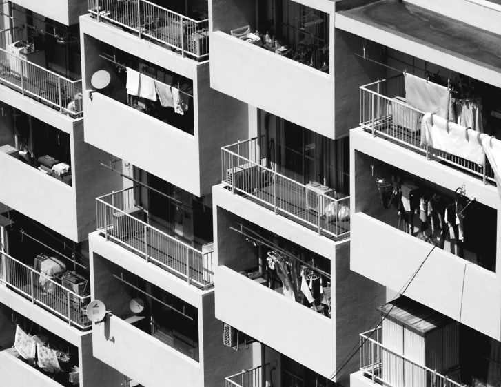 a black and white picture shows balcony balconies with laundry hanging