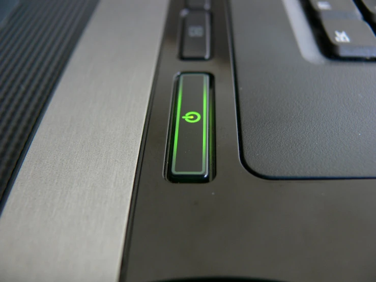 a close up of a green key on top of a computer