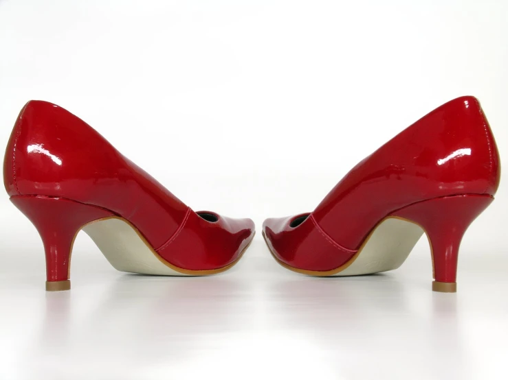 red and white high heeled shoes are facing opposite directions