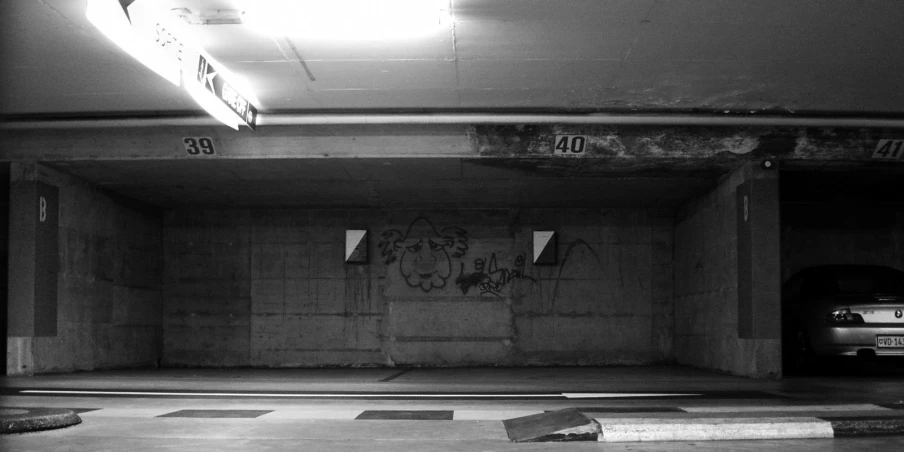 a black and white image of an abandoned parking garage