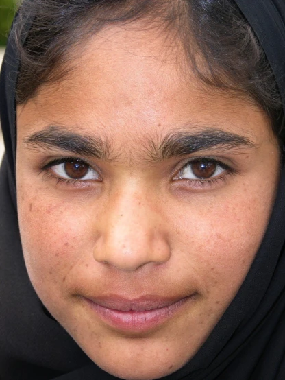 a close up of a person wearing a headscarf