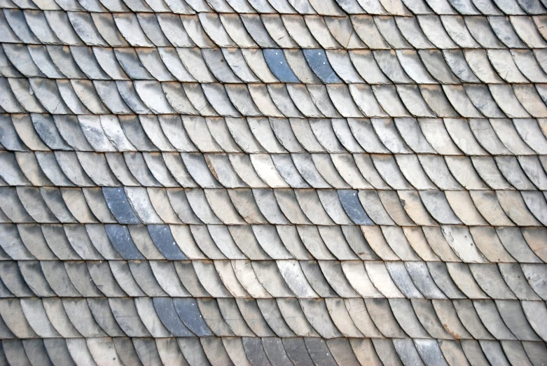 there is a long line of small blue grey wavy ridges on the roof of a house