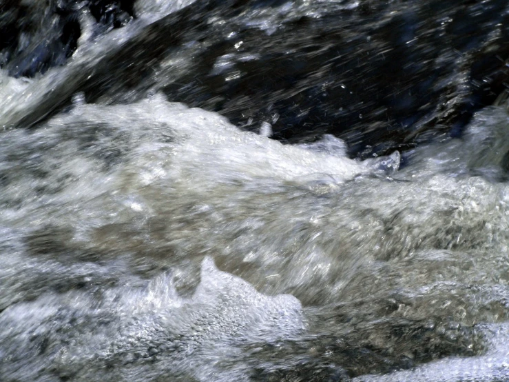 water being splashed on rocks with flowing water