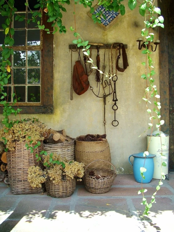 baskets and planters sitting against a stucco wall