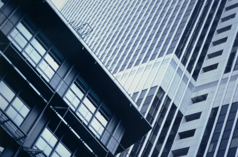 two skyscrs towering over the ground near each other