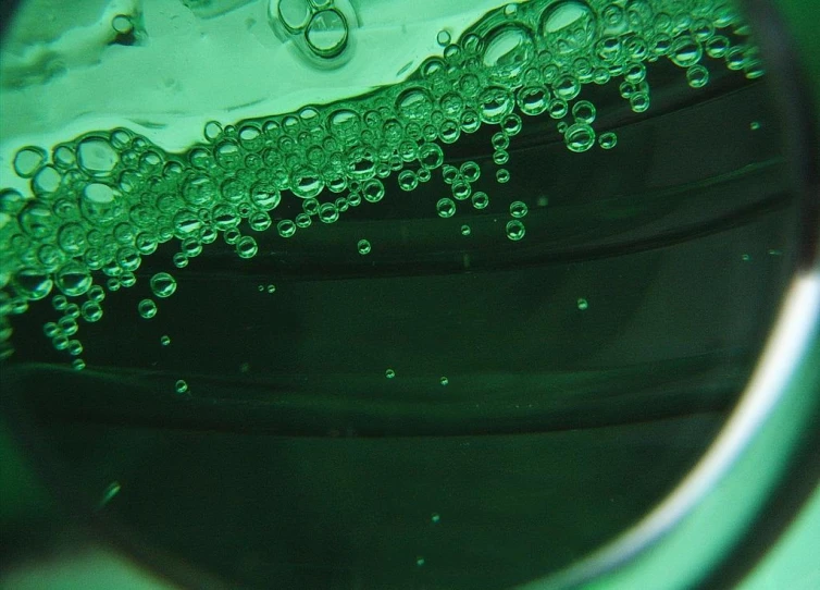 a closeup of a glass with water drops