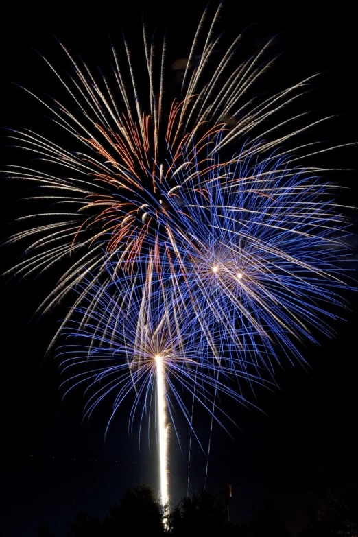 a fireworks with blue smoke is seen in the background