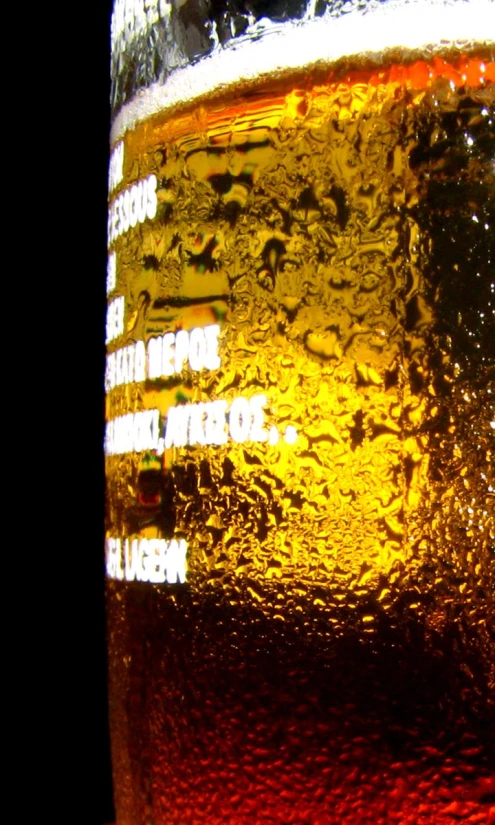 a glass full of beer sitting on top of a table