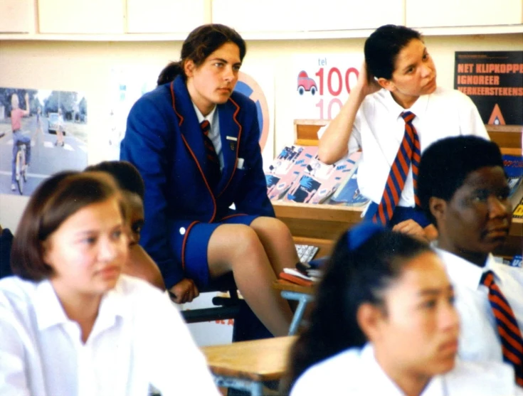 a group of students sitting down on their desks