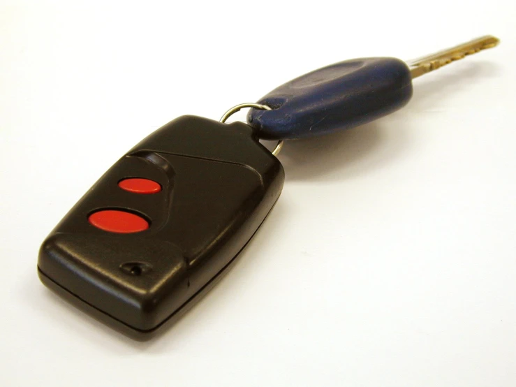 a black car key that has a red light on it