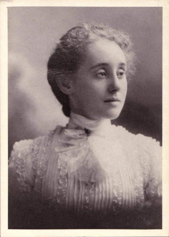 a lady with a collared shirt posing for a portrait