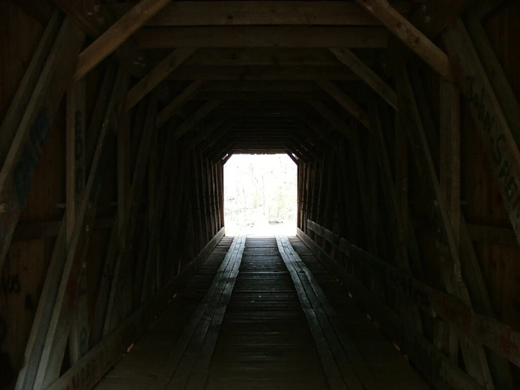 a view of an empty tunnel of wood on the side of a building