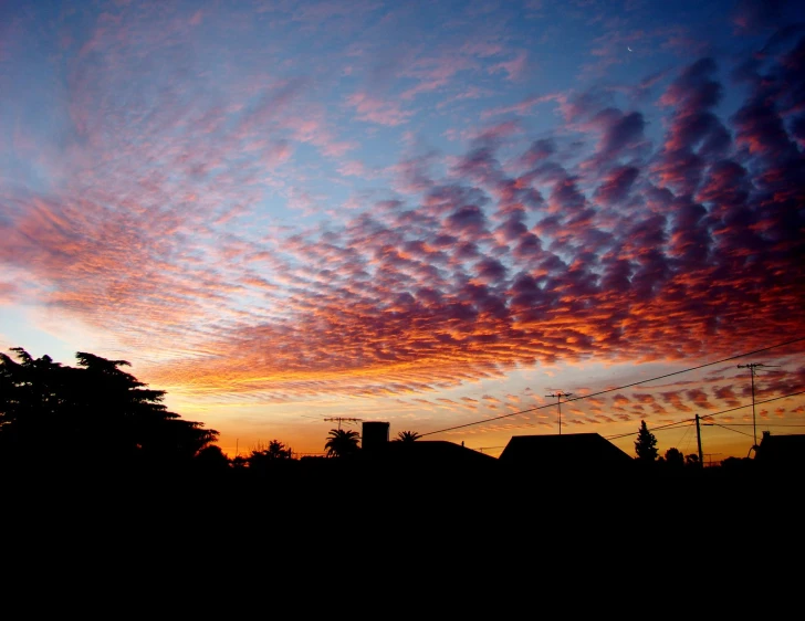 the sky has red clouds during this time of day