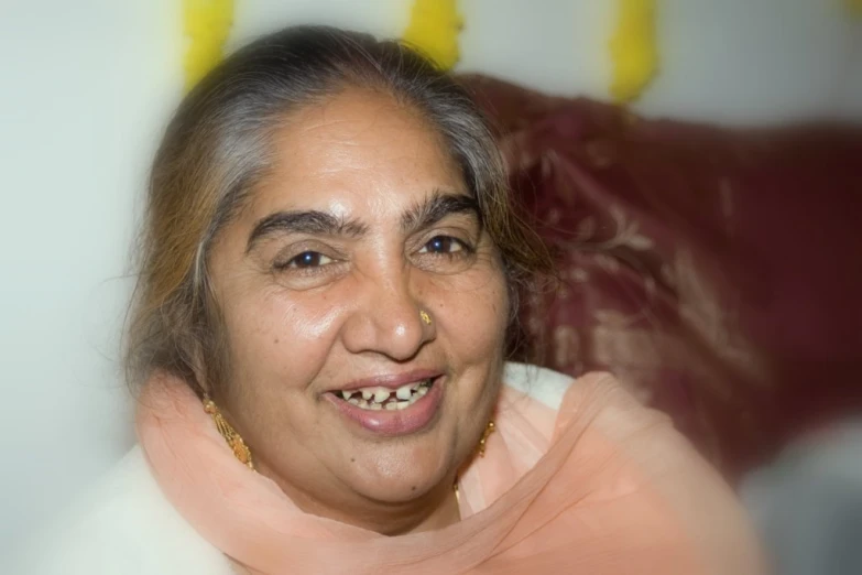 a smiling woman sitting on top of a red couch