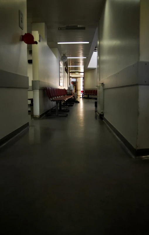 a long hallway with some chairs lined up next to the side