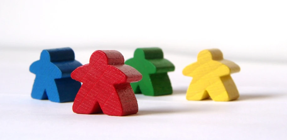 colorful wooden figures of people facing towards each other