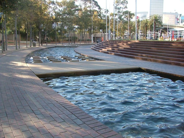 a public plaza near some buildings and water