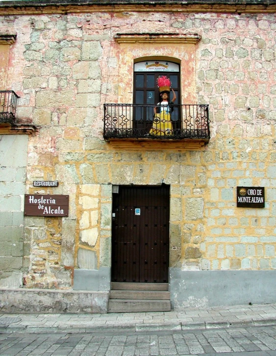 a woman is standing in the window of an old building