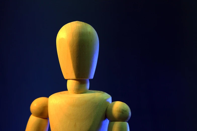 a yellow robot with big legs in the dark