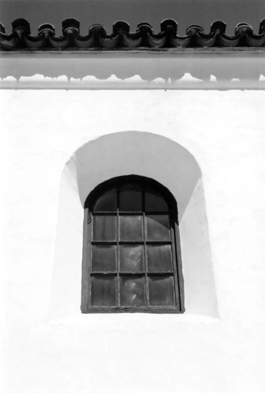 the window with a rope railing is shown in black and white