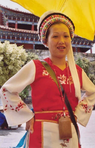 a woman in traditional china attire, holding an umbrella