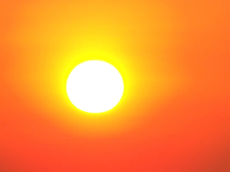 the sun with its face obscured in the bright sky