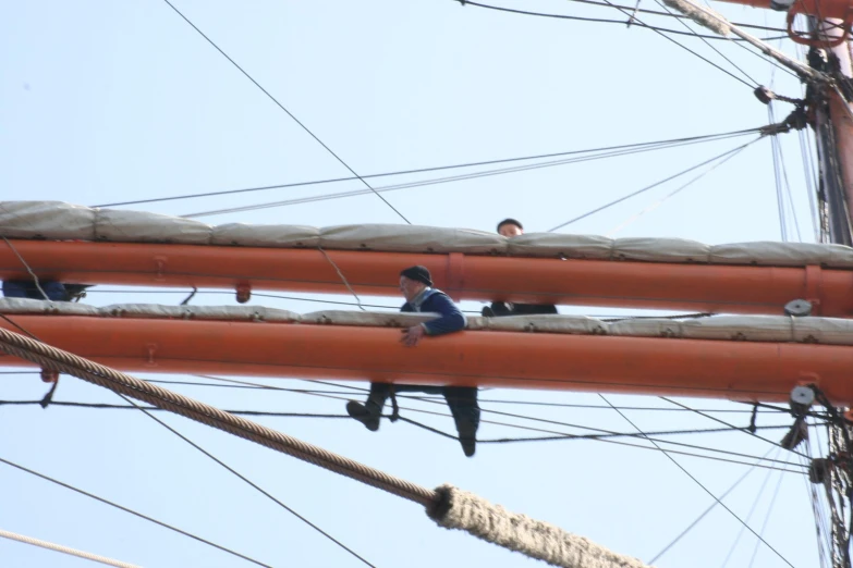 a man is sitting on the power lines