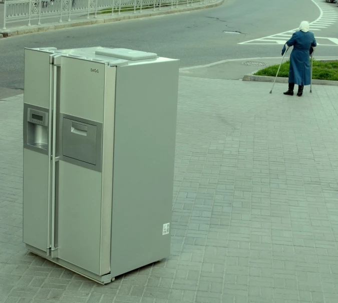 a street scene showing a refrigerator next to the sidewalk