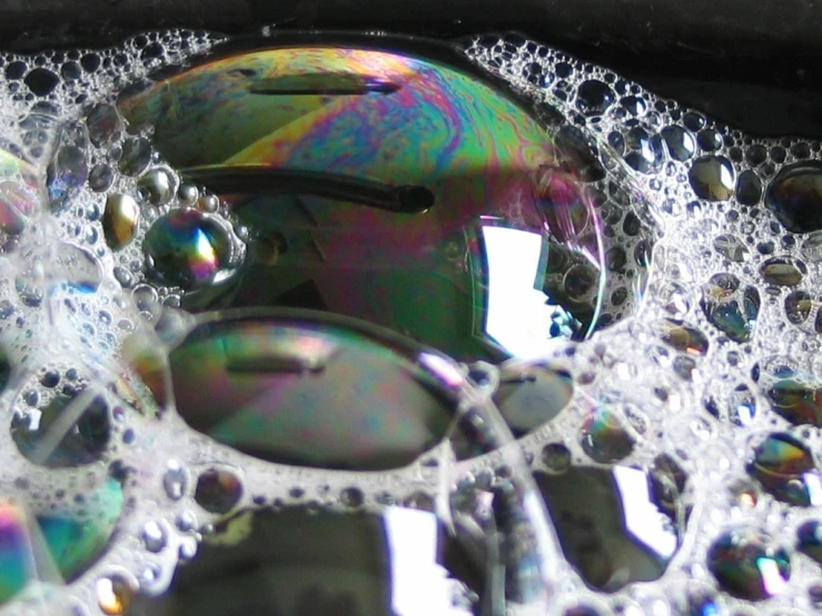 there is a multi - colored disk and bubbles in this pograph