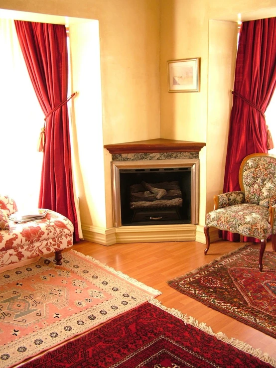 a room with two different colored couches next to a fireplace