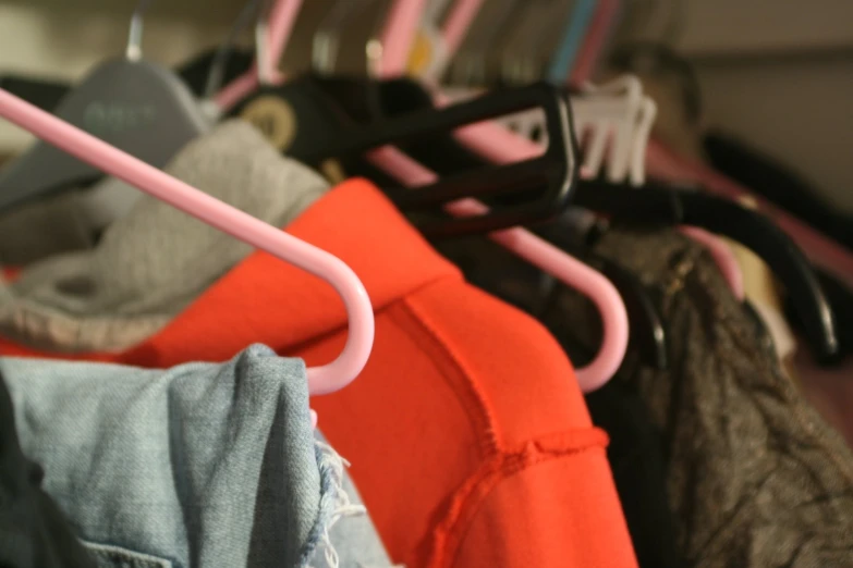 many clothes hangers are hanging on a rack