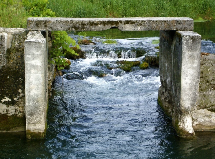 a bridge that goes over the water in a creek