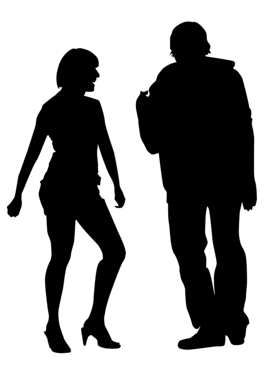 a silhouette of two people standing in front of each other