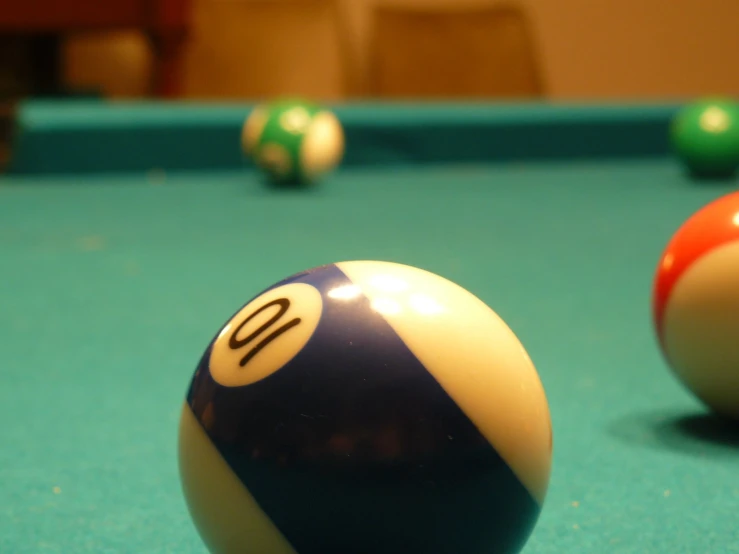 three balls lined up in the corner of a pool table