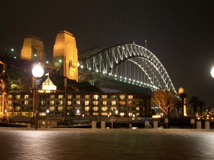 the large building has a curved bridge over it