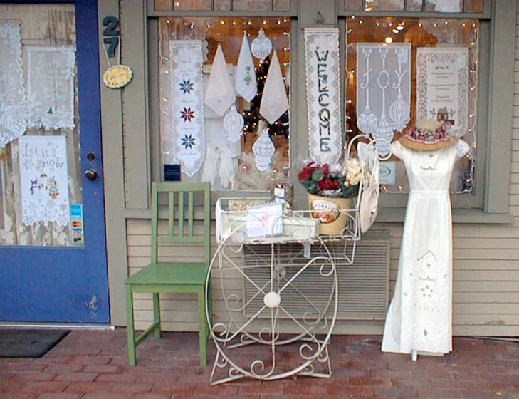 an antique metal clothes rack in front of a store