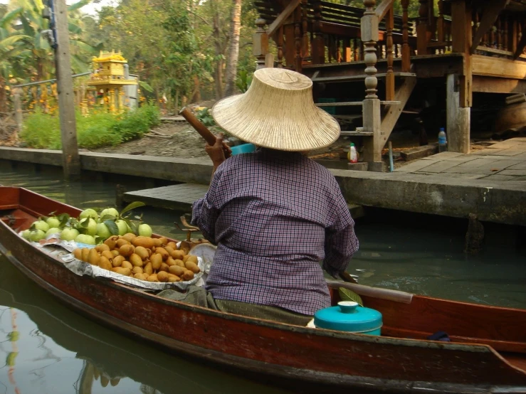 a person on a boat with food on the ground