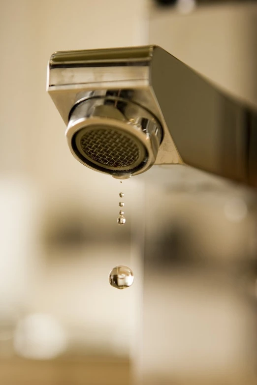 a closeup of a shower head showing the water flowing