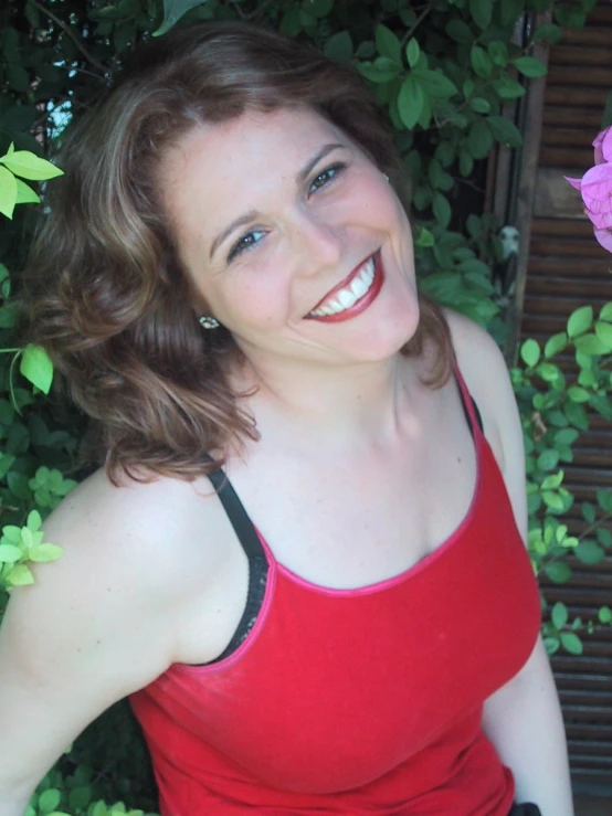 a woman with brown hair in a red top