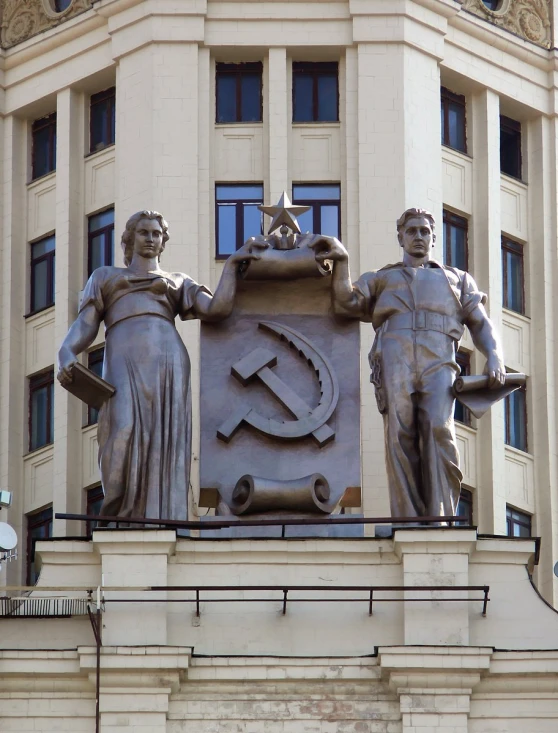 a statue of two men standing in front of a building